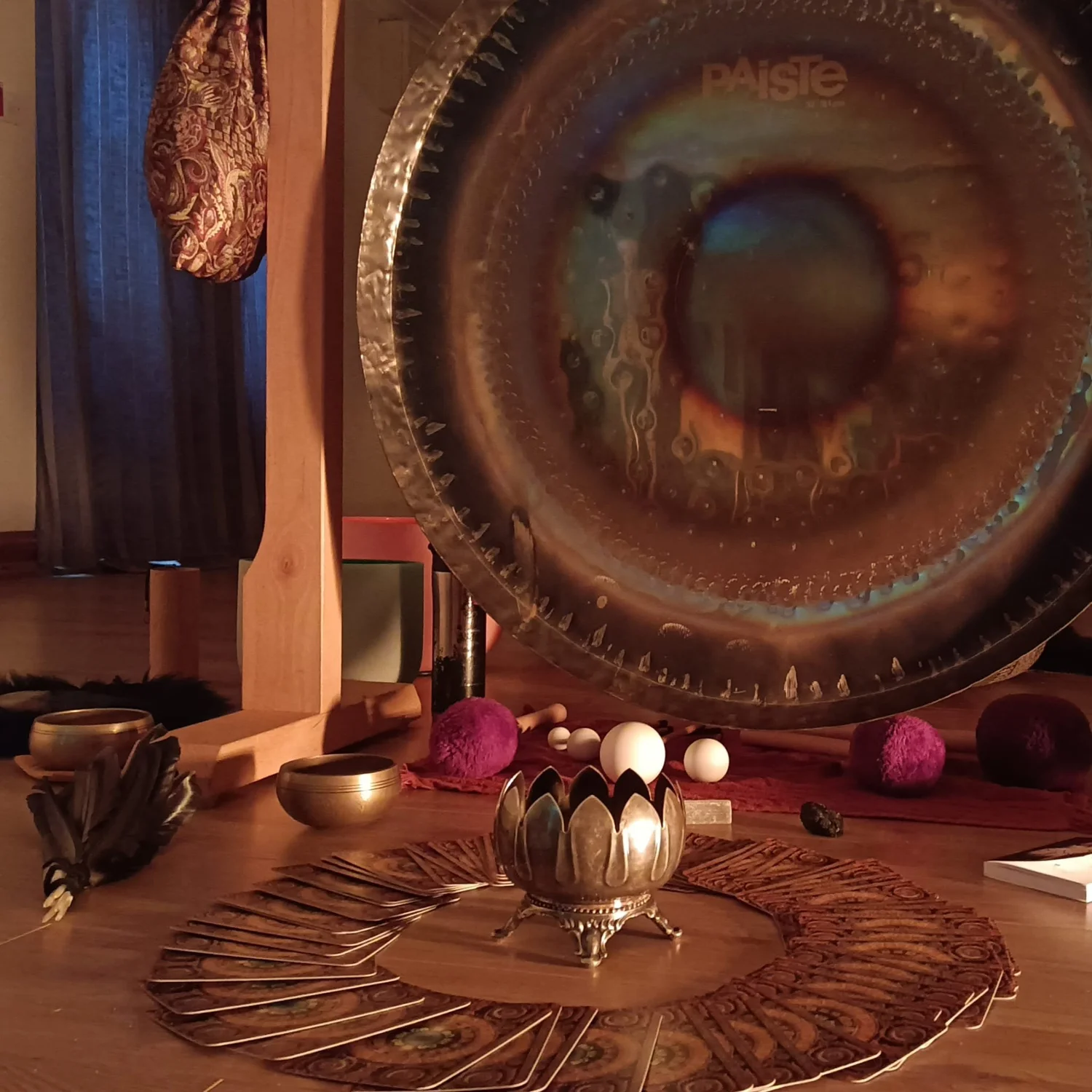 Gongs and instruments set up in a fairy-lit space