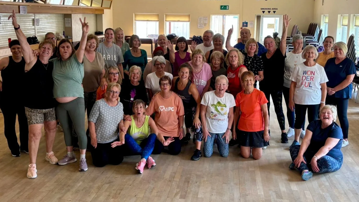 A big, beaming Bumba Fitness class group in the hall at the Rosary Club, Ipswich