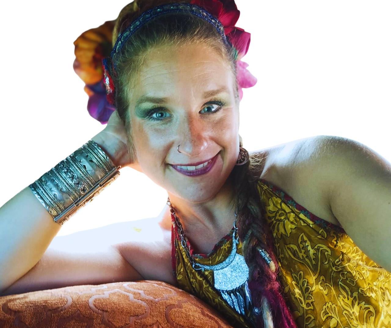 Saz smiling, flowers in her hair and silver bangles up one arm