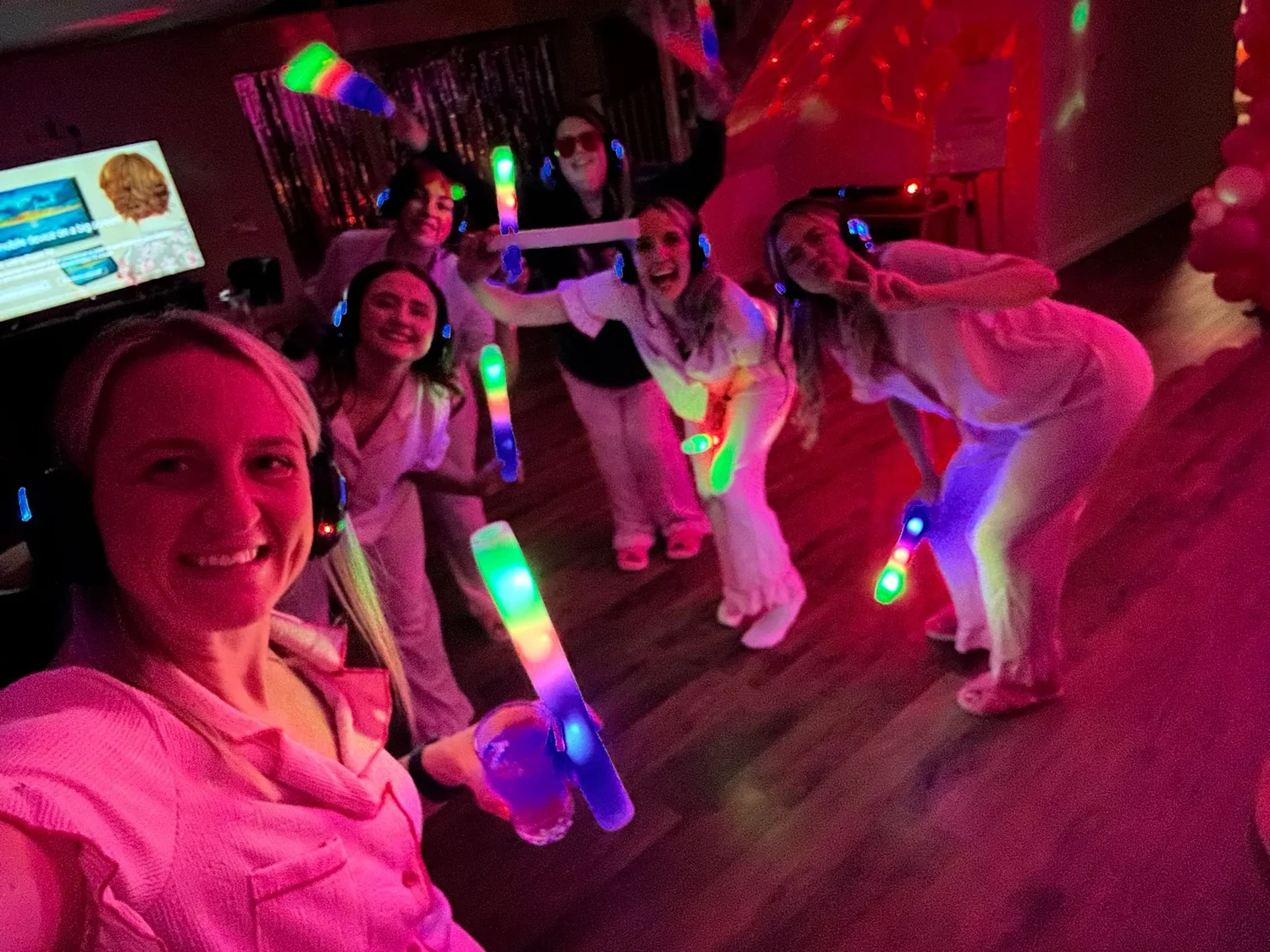 Silent disco guests wearing glowing headsets